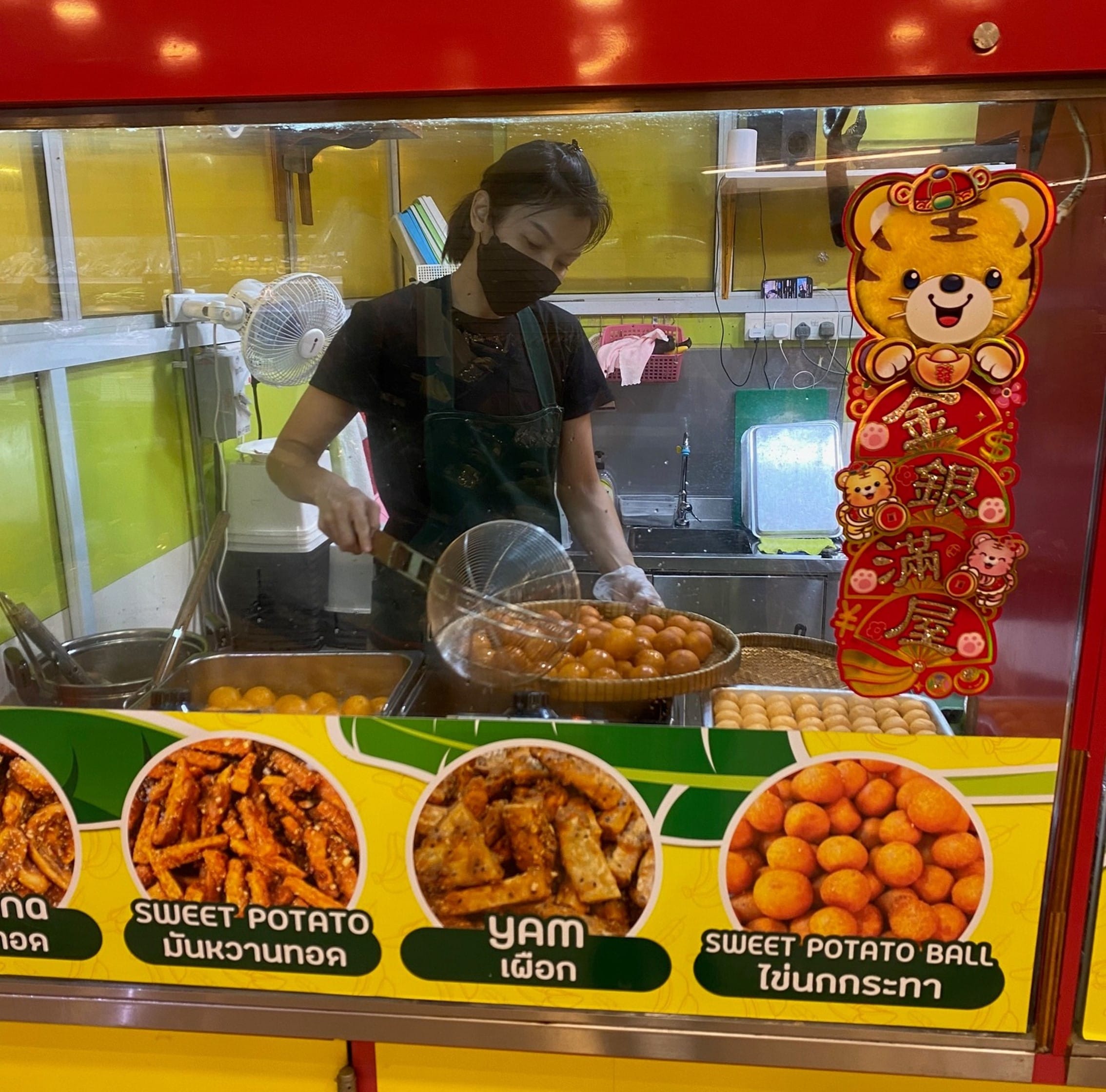 Street food freshly made just inside the entrance of the Thai supermarket, 2022.